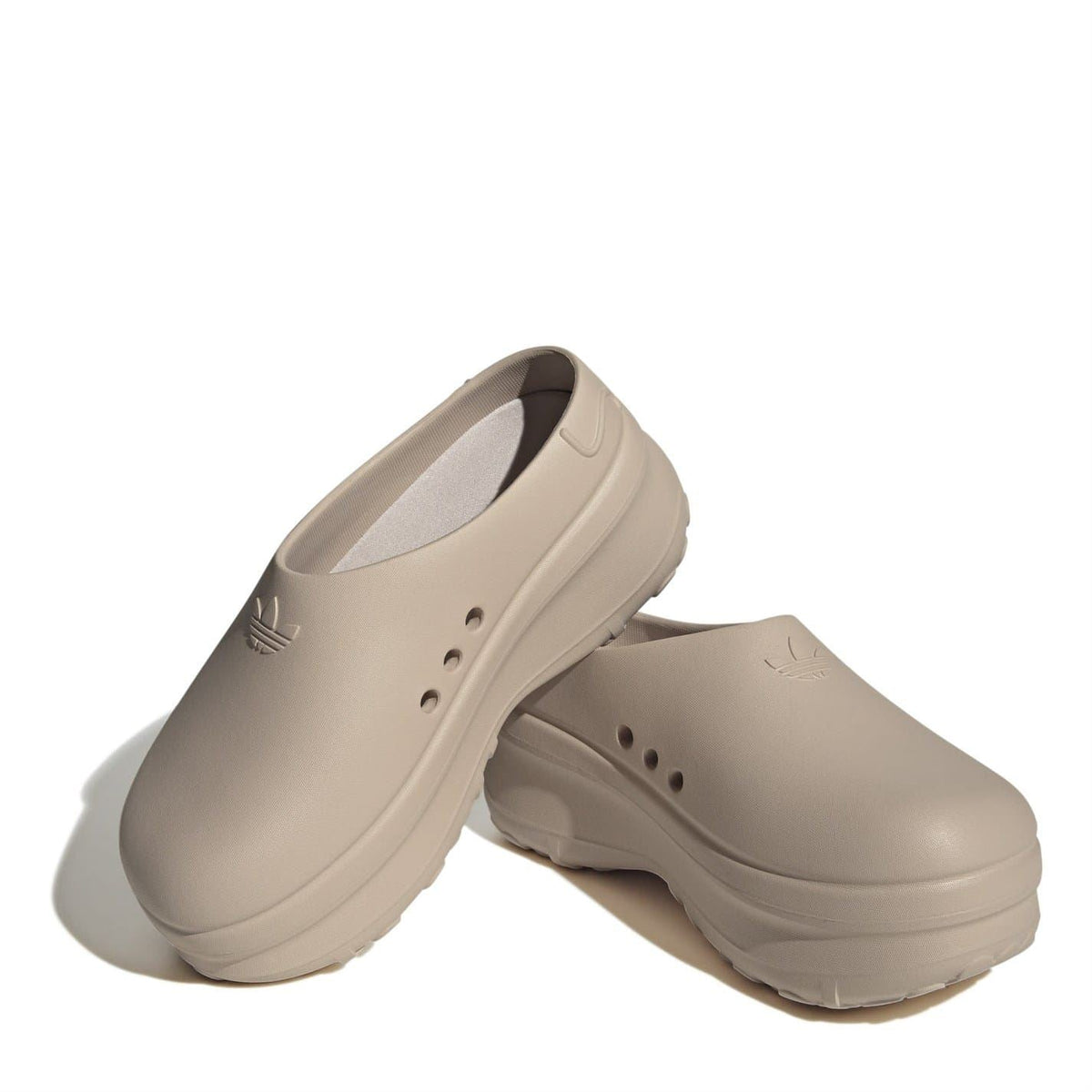Beige low-top slip-on trainers shown from side with inner lining and ventilation holes