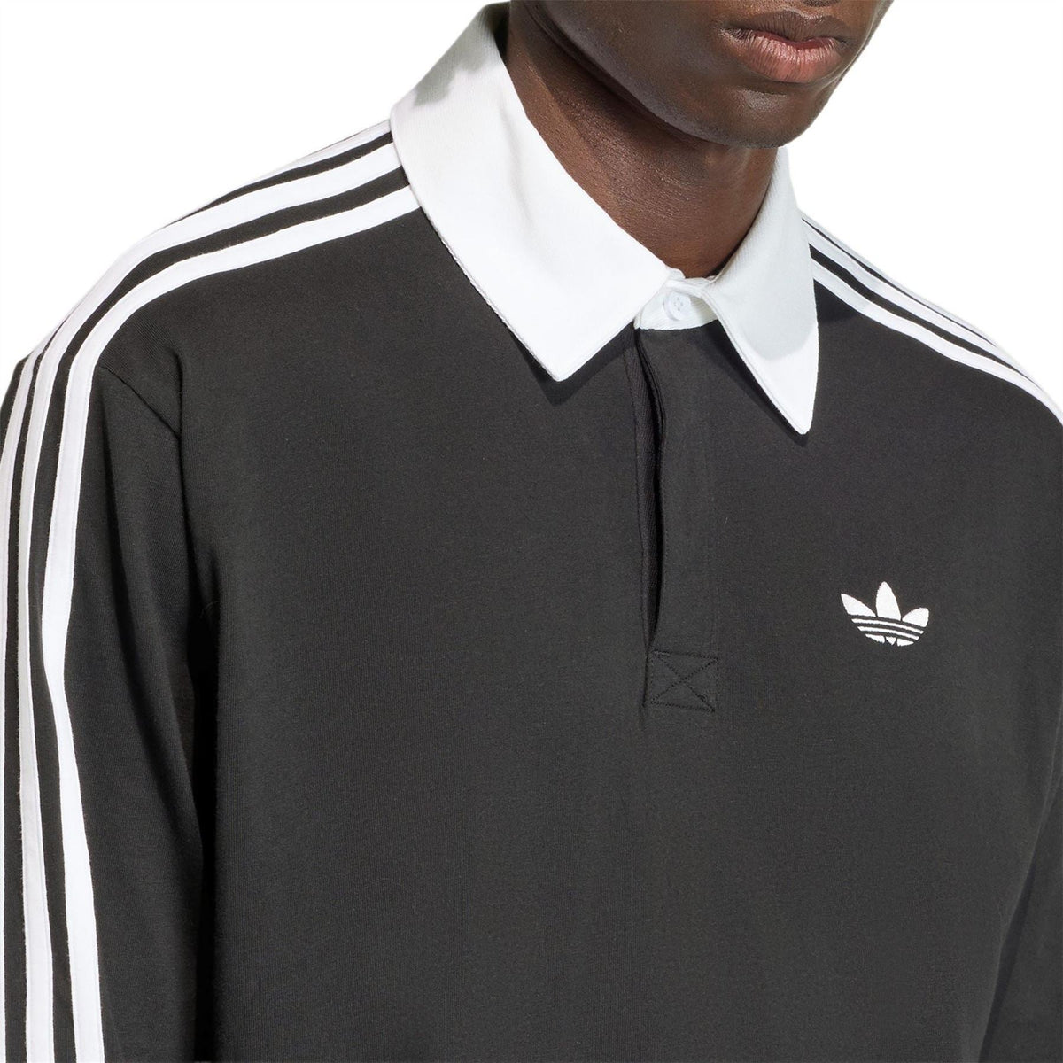 Black long-sleeve polo with white collar, adidas logo, and white shoulder stripes