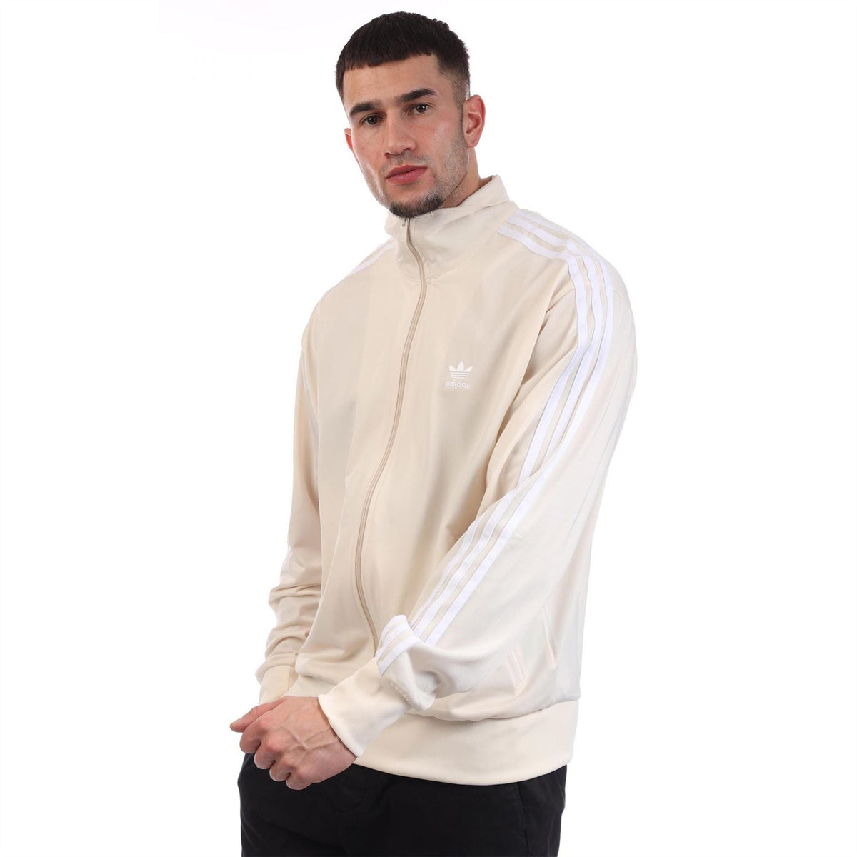 adidas Originals Classics Firebird Track Top in black with white stripes, displayed on a hanger against a white background.