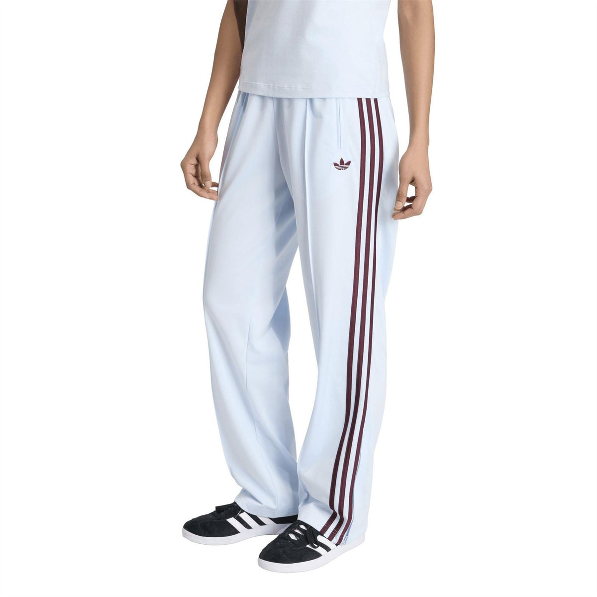 Womens white track joggers with side triple stripes and adidas trefoil logo
