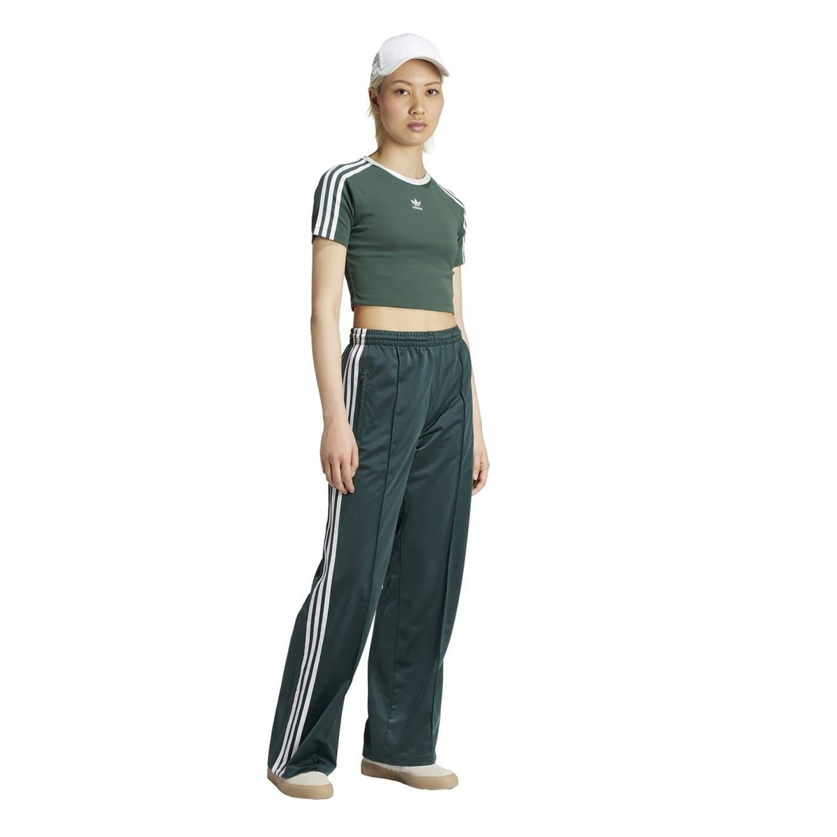 adidas Originals dark teal track pants with white side stripes, wide leg fit, elastic waist