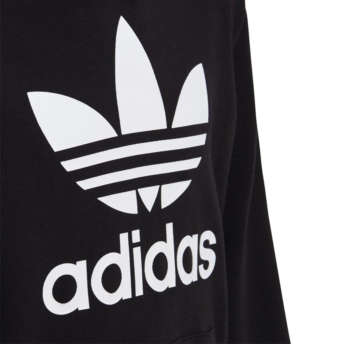 Black hoodie sleeve with large white adidas trefoil and adidas wordmark