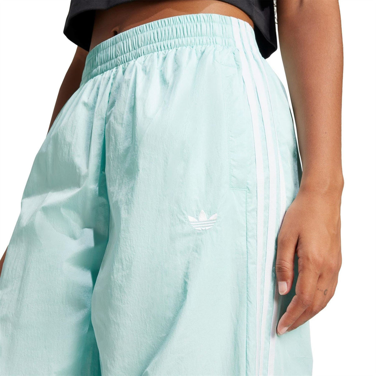 Light aqua track pants with elastic waistband and adidas trefoil logo on leg