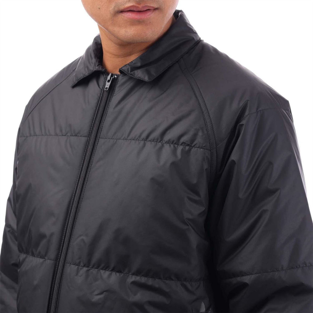 adidas Originals black coach jacket close-up, full-zip front and stand collar