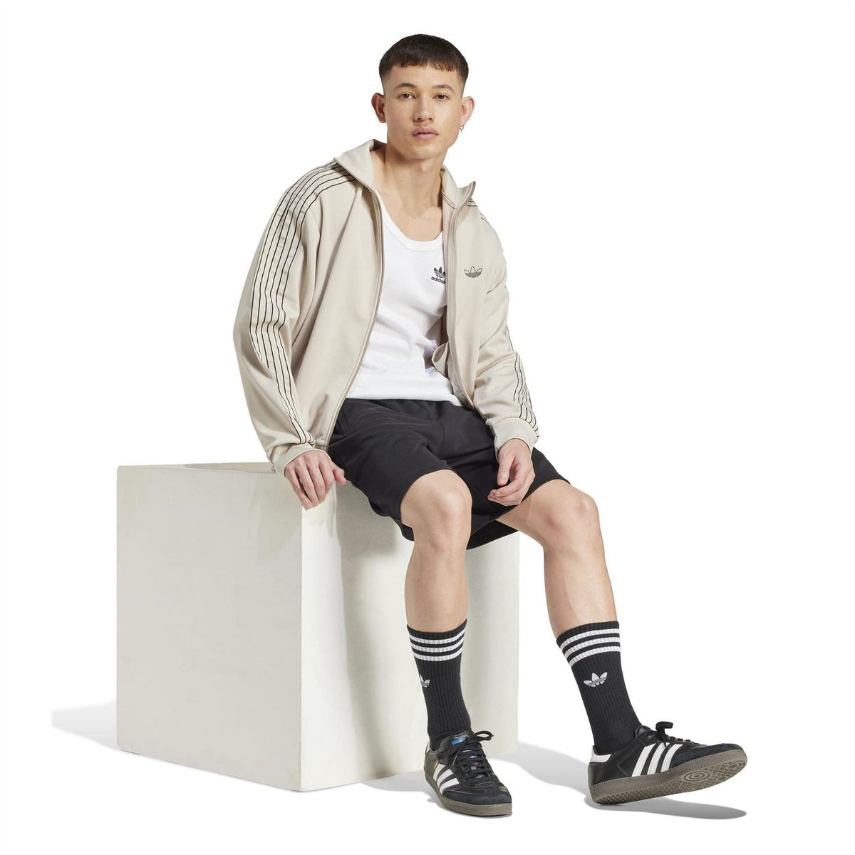 Black sweat shorts with adidas logo, elastic waistband, knee-length cut
