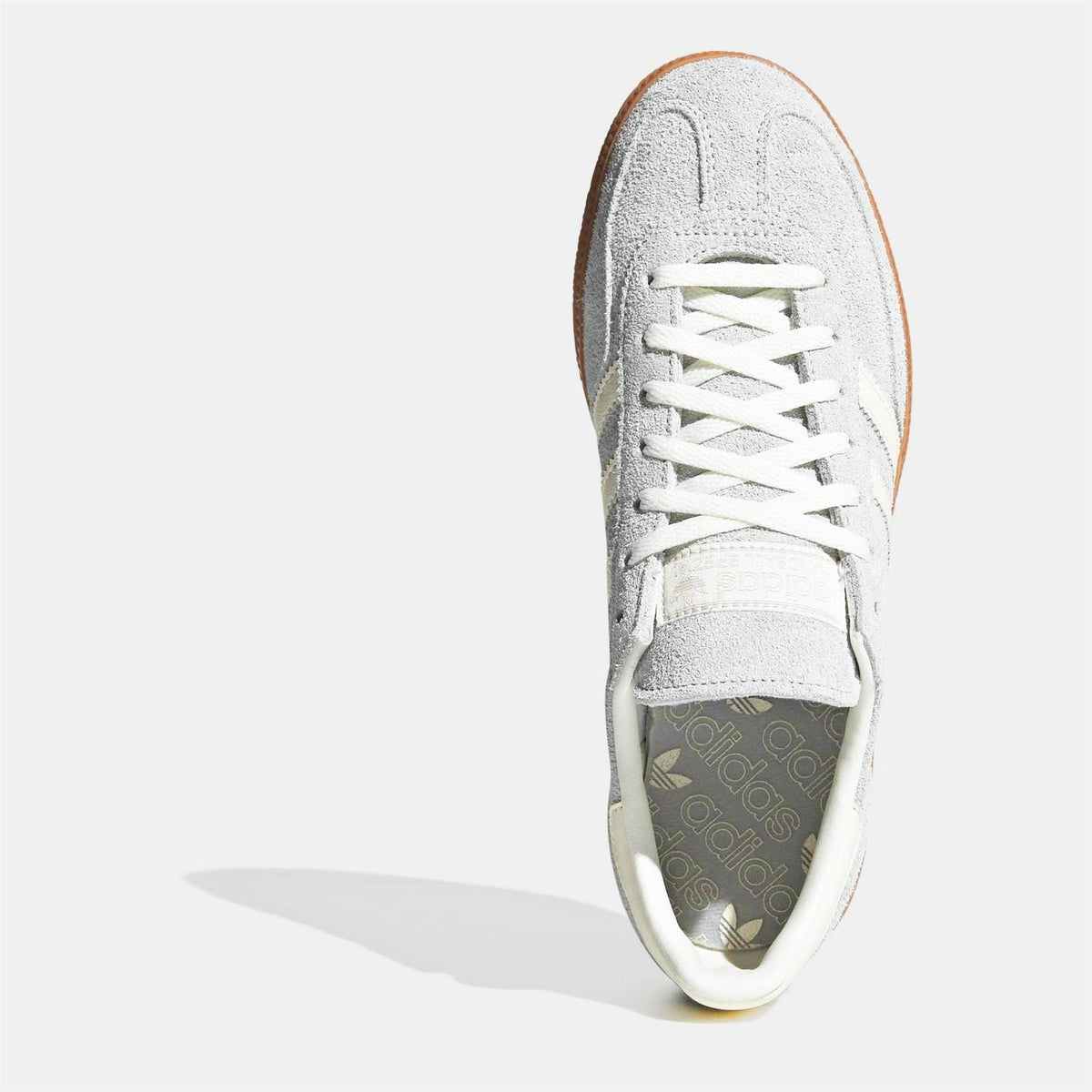 White suede sneaker with lace-up front and cushioned padded collar
