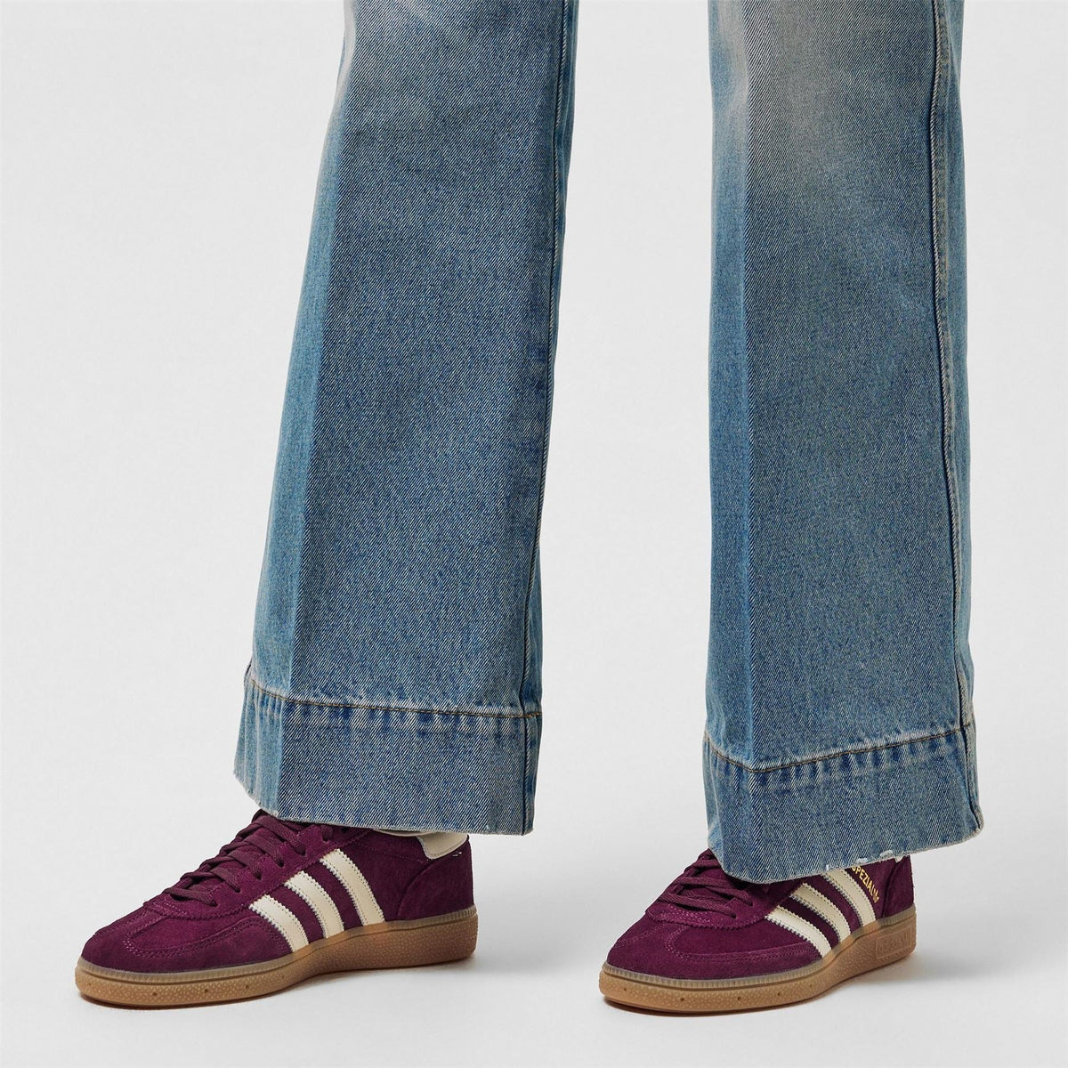 adidas Originals Spezial shoes in maroon, worn with blue jeans cuffs