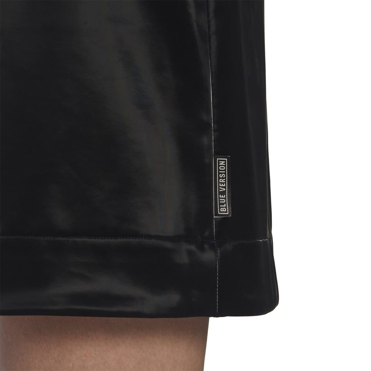 Black skirt hem with Blue Version label on side seam