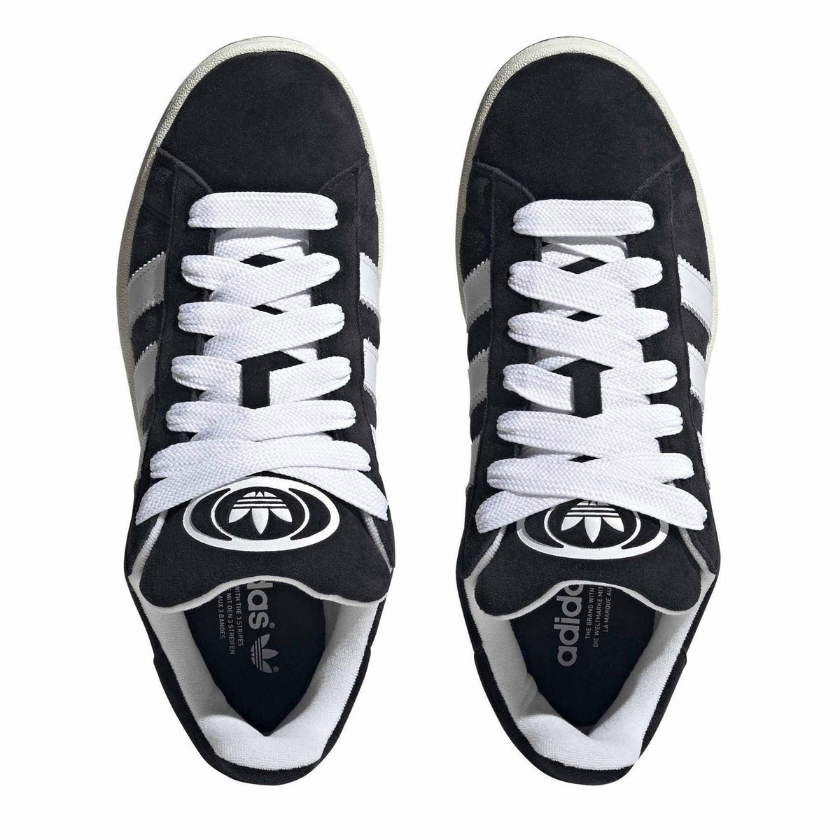 Pair of black adidas Originals sneakers with white laces and Trefoil logos on tongues