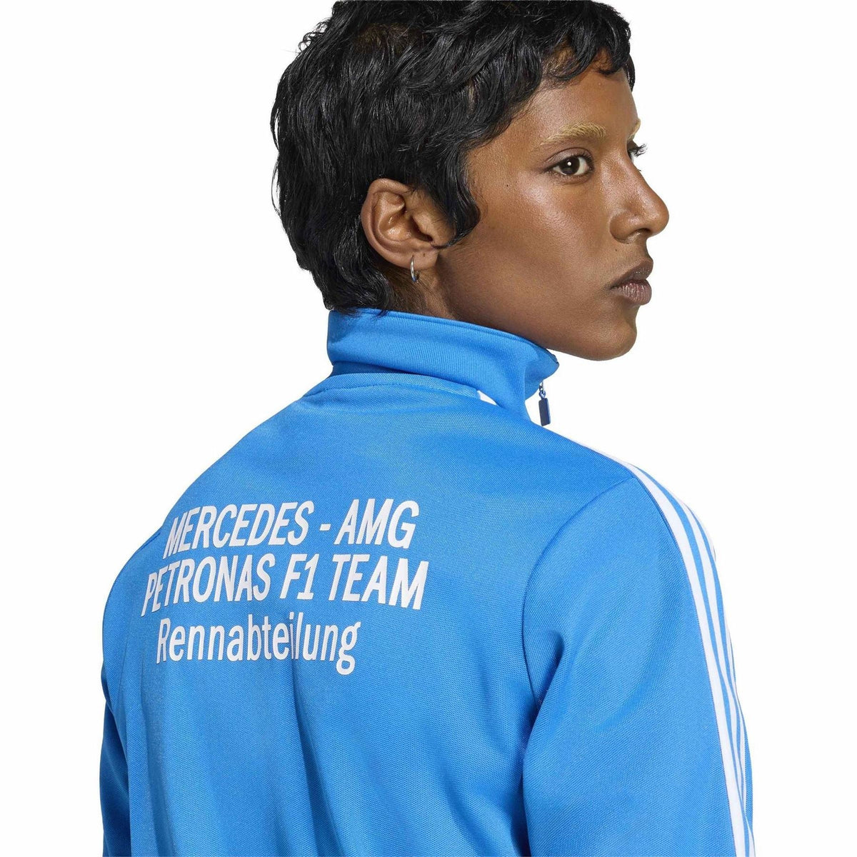 Blue track top back detail with 'MERCEDES-AMG PETRONAS F1 TEAM' text; white stripe accents.