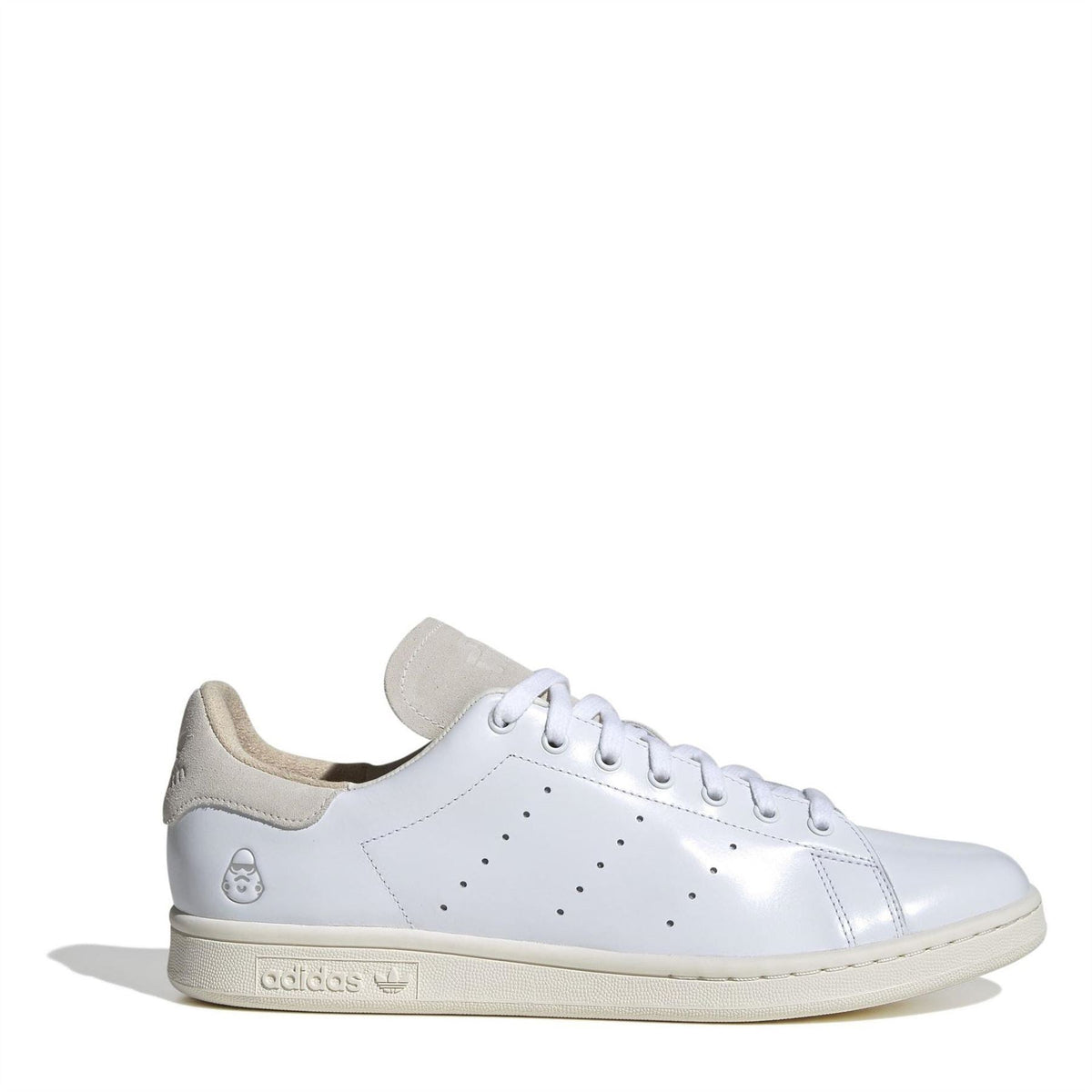 White low-top leather-style sneakers with beige suede heel and adidas logo