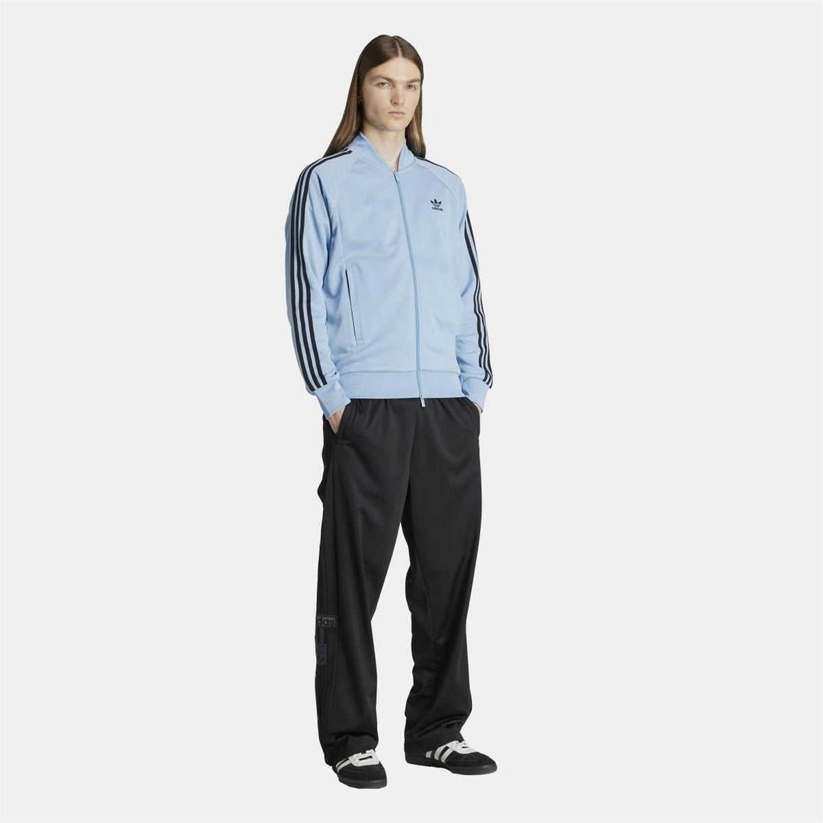 adidas Originals Classic SST track jacket in navy with white stripes, featuring full-zip front and ribbed cuffs.