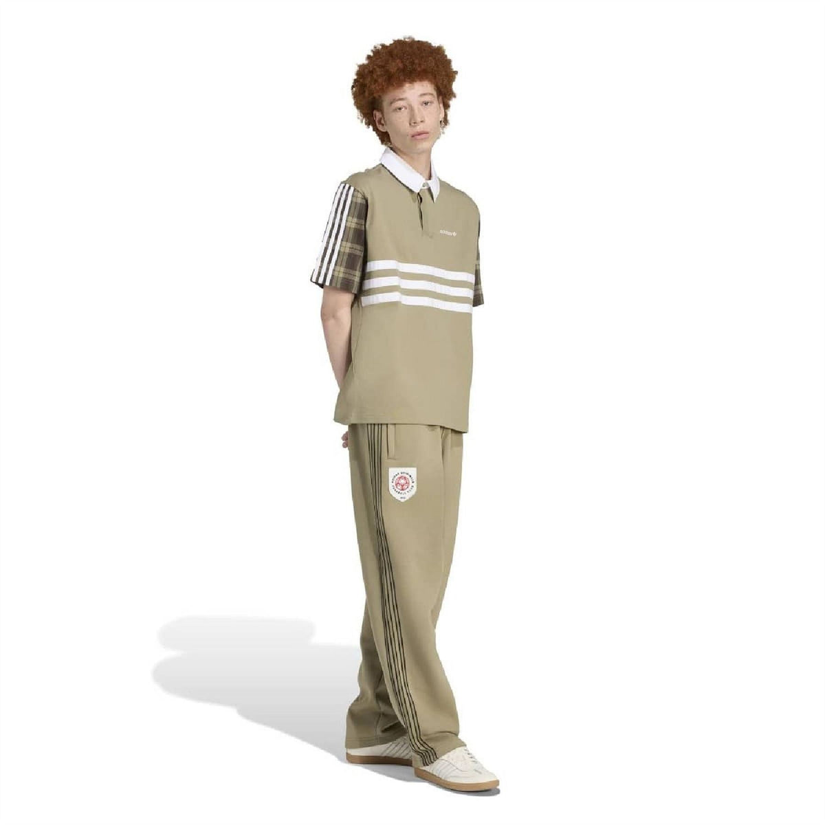 Olive-green joggers with adidas crest patch and matching side stripe panels