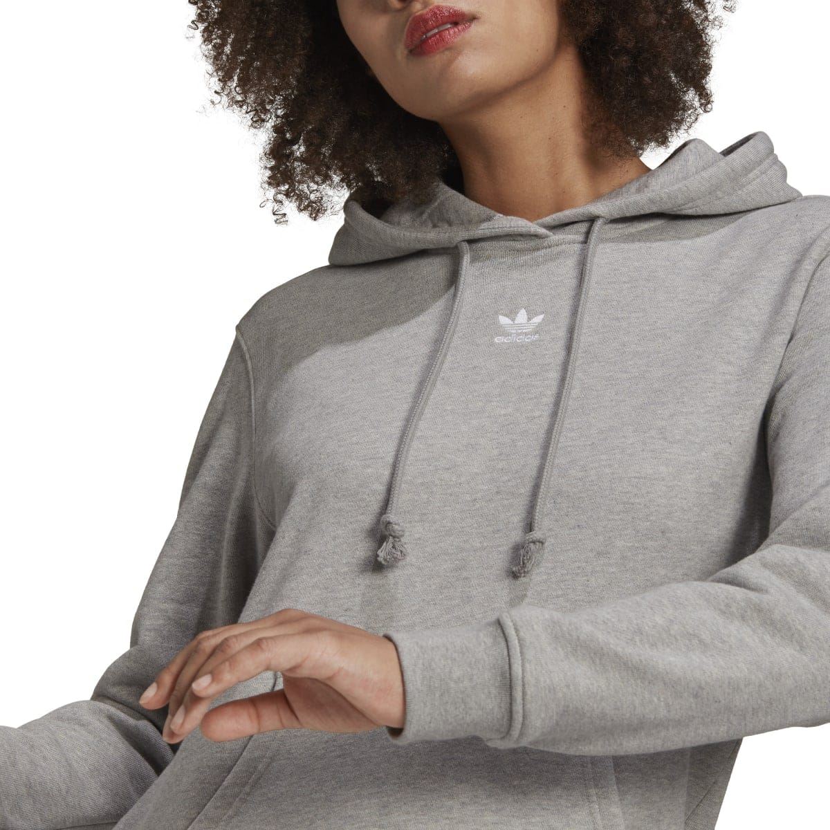 Grey heather hoodie close-up showing hood drawstrings and small chest logo