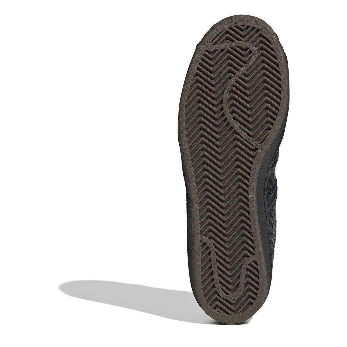 Black rubber outsole with herringbone tread pattern on low-top sneaker