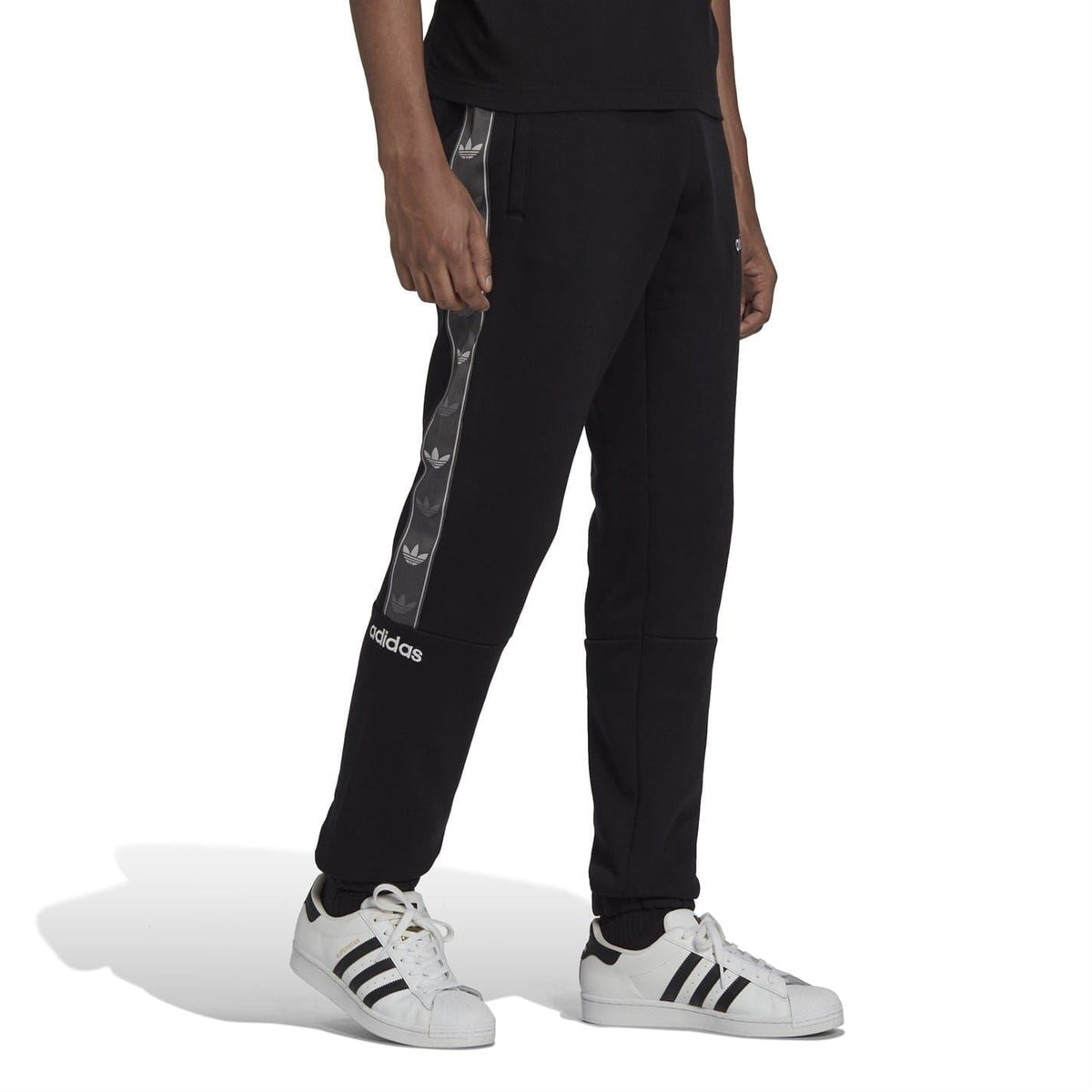 Black fleece joggers with vertical side logo tape and elastic ankle cuffs