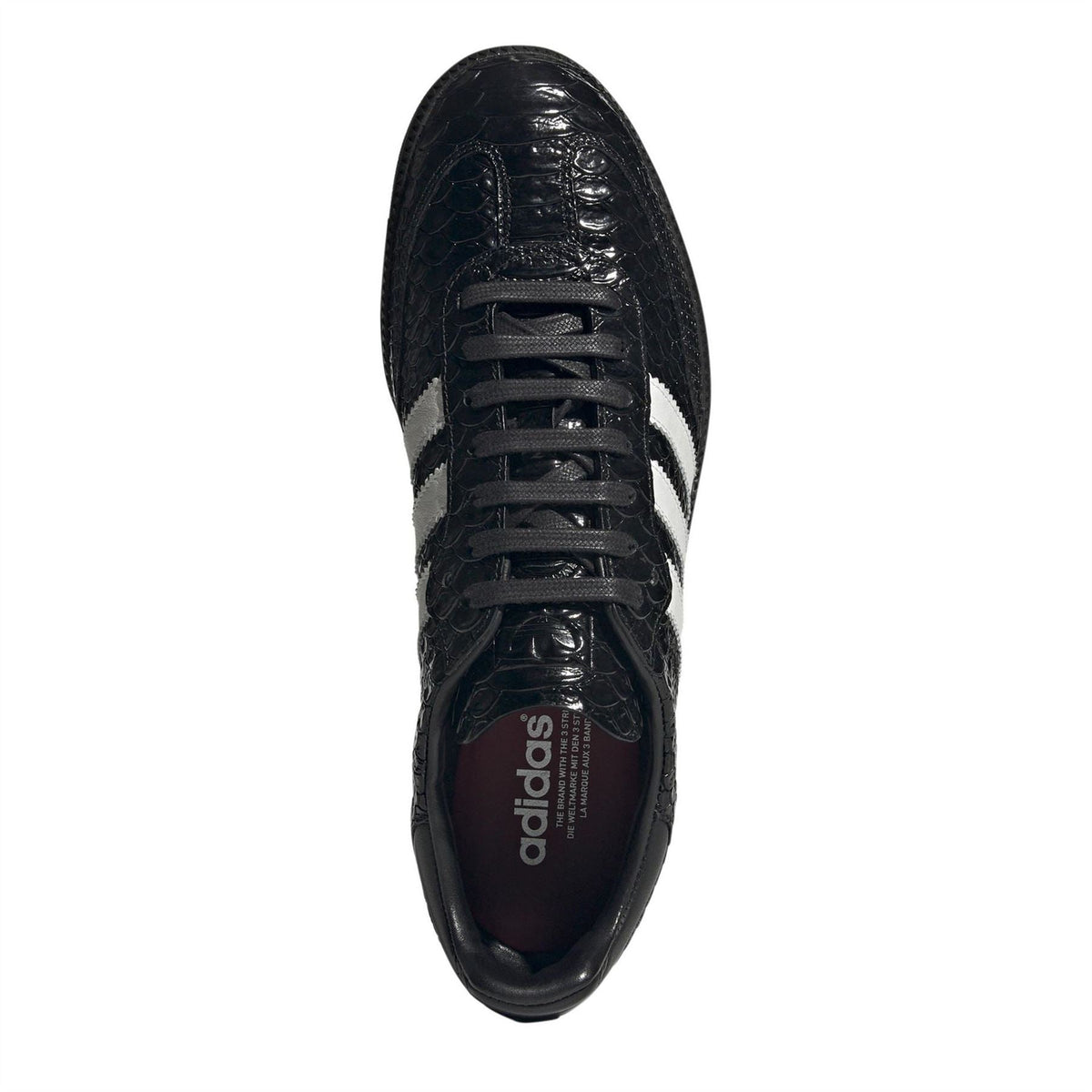 Black lace-up sneakers with adidas logo on tongue