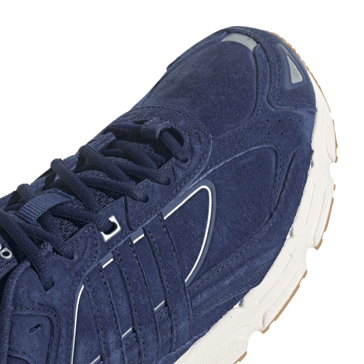Close-up of navy suede adidas Response CL sneaker upper with lace eyelets and overlay panels