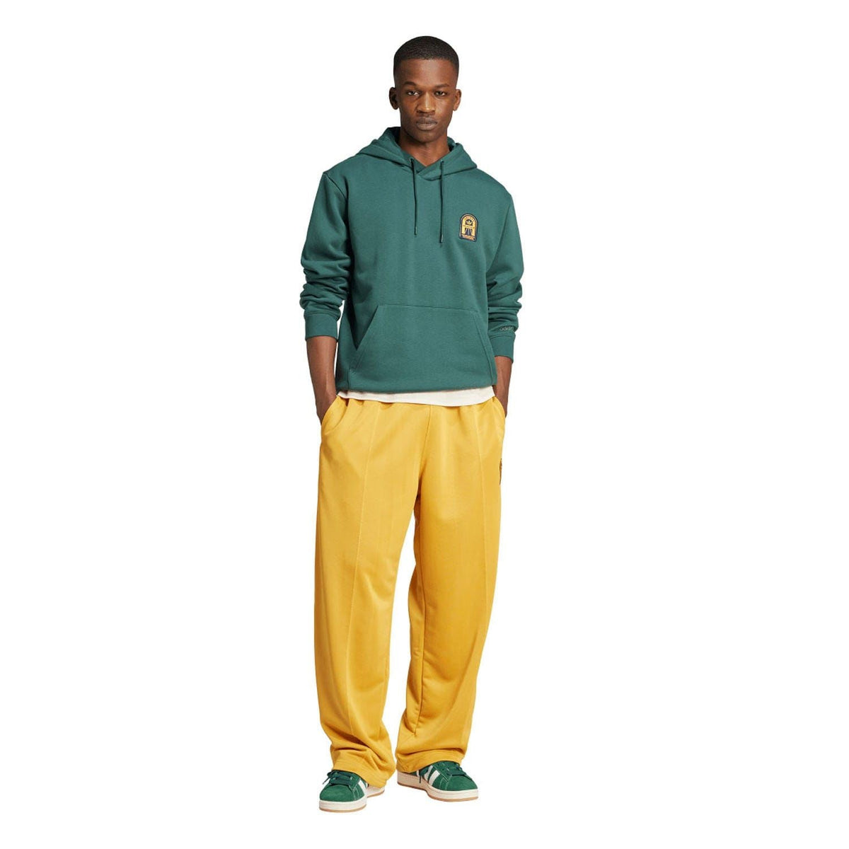 Green adidas Originals hoodie worn with yellow jogger pants, front view