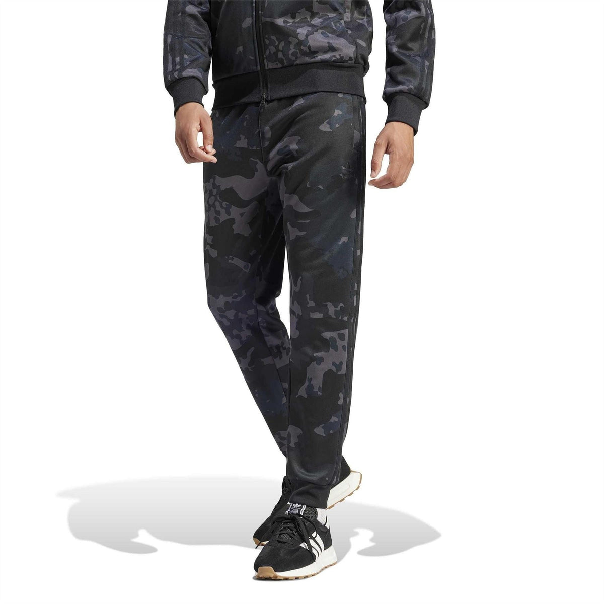 adidas Originals camo track pants with tapered legs, elastic waistband and ankle cuffs