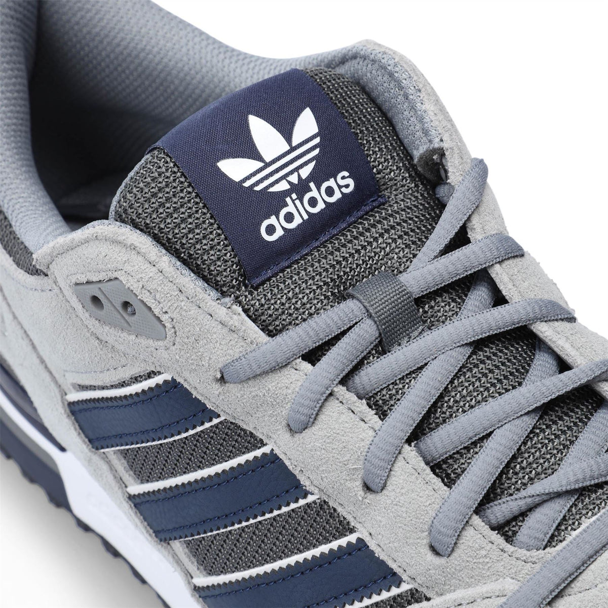 Grey and navy ZX 750 sneaker with adidas tongue logo and lace-up detail