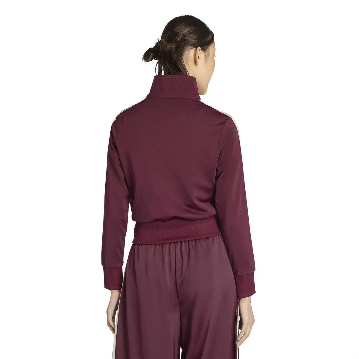 Maroon women’s track jacket back view with white side stripes and elastic waist cuff.