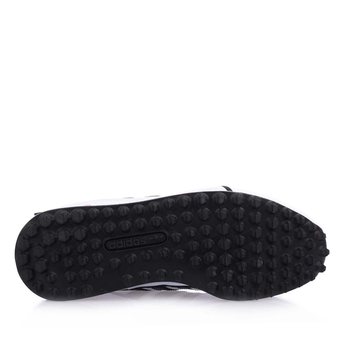 White junior Adidas sneakers outsole, black textured tread with adidas mark.