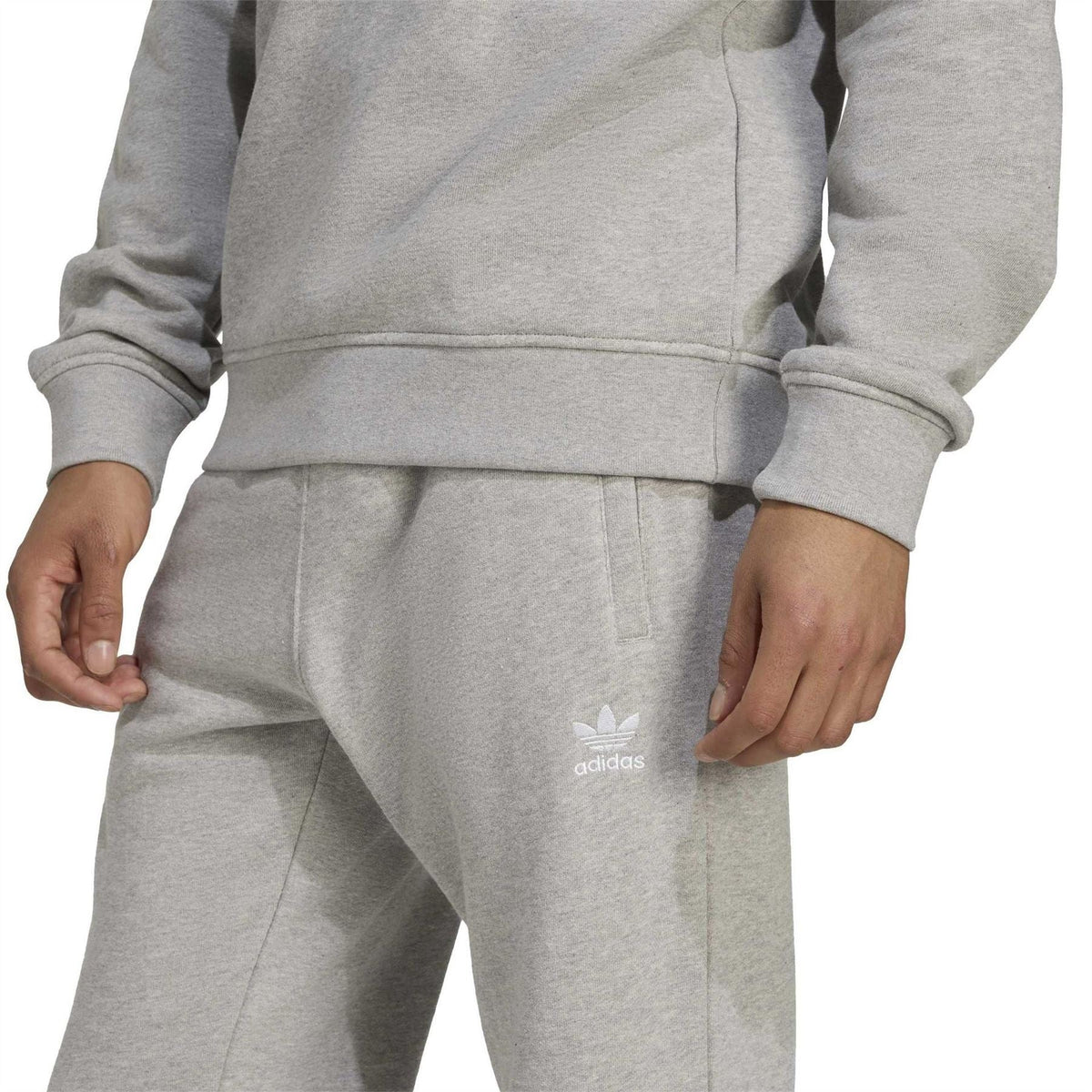 Heather grey jogger pants with adidas logo trefoil on lower leg