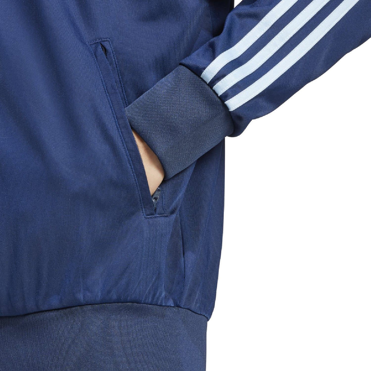 Indigo adidas track jacket sleeve with ribbed cuff and white triple stripe detail