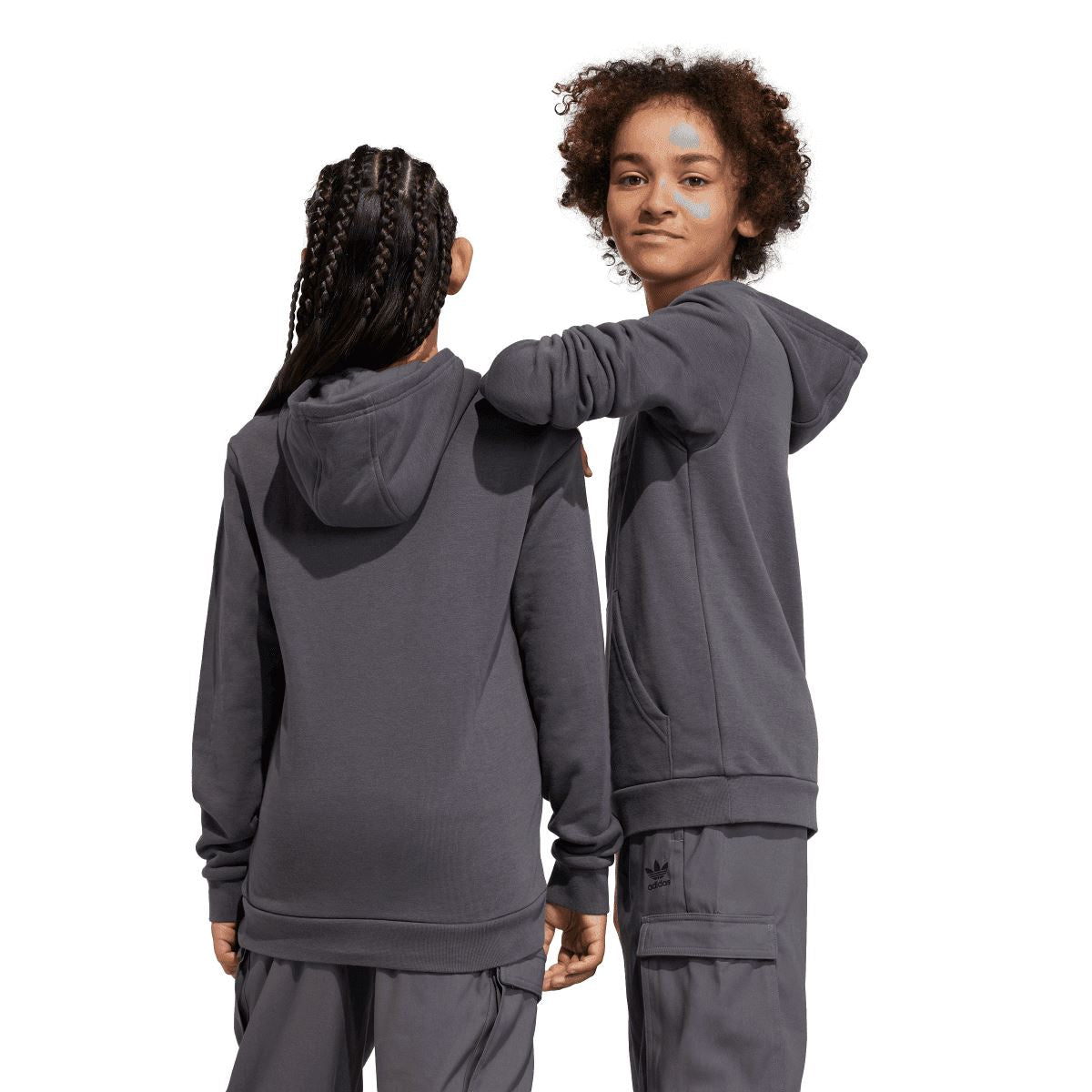 Grey junior adidas hoodie on model, showing hood and full front with Trefoil logo