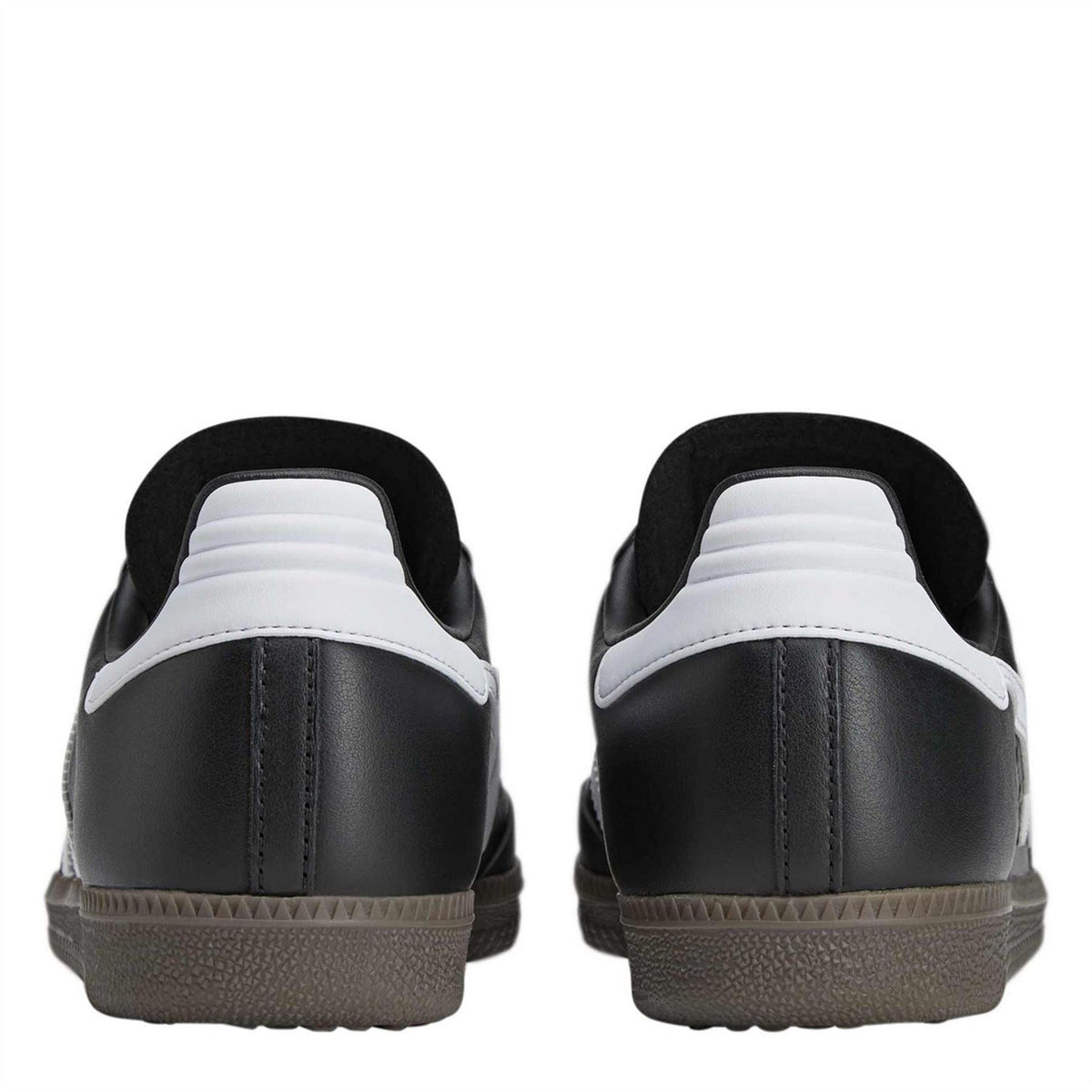 Black low-top sneakers with white heel accents and textured rubber outsole