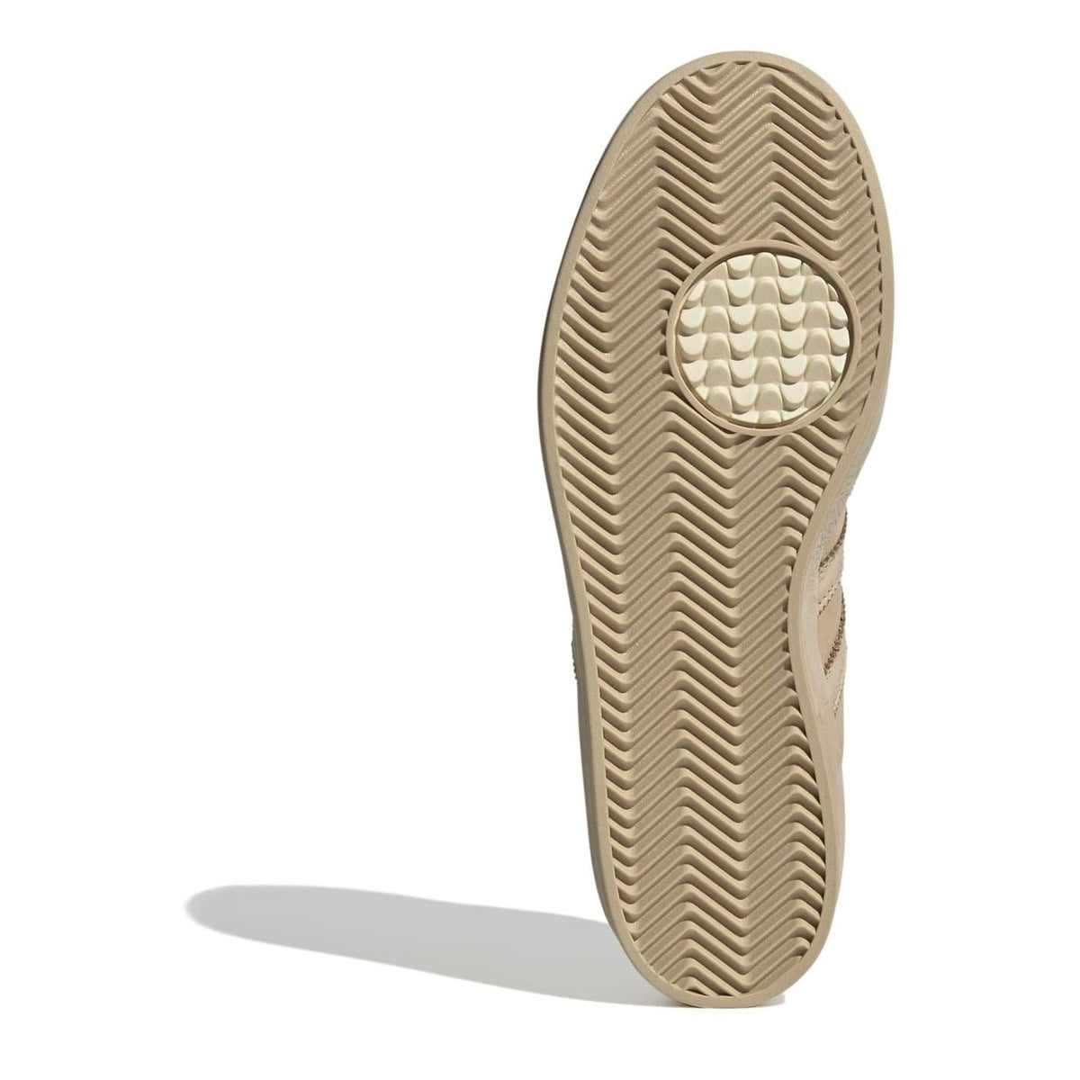 Beige sneaker outsole with textured herringbone tread pattern