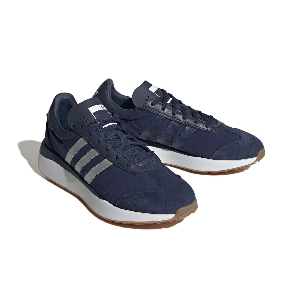 adidas Originals Courty XLG trainers in navy, two pairs shown with white triple stripes
