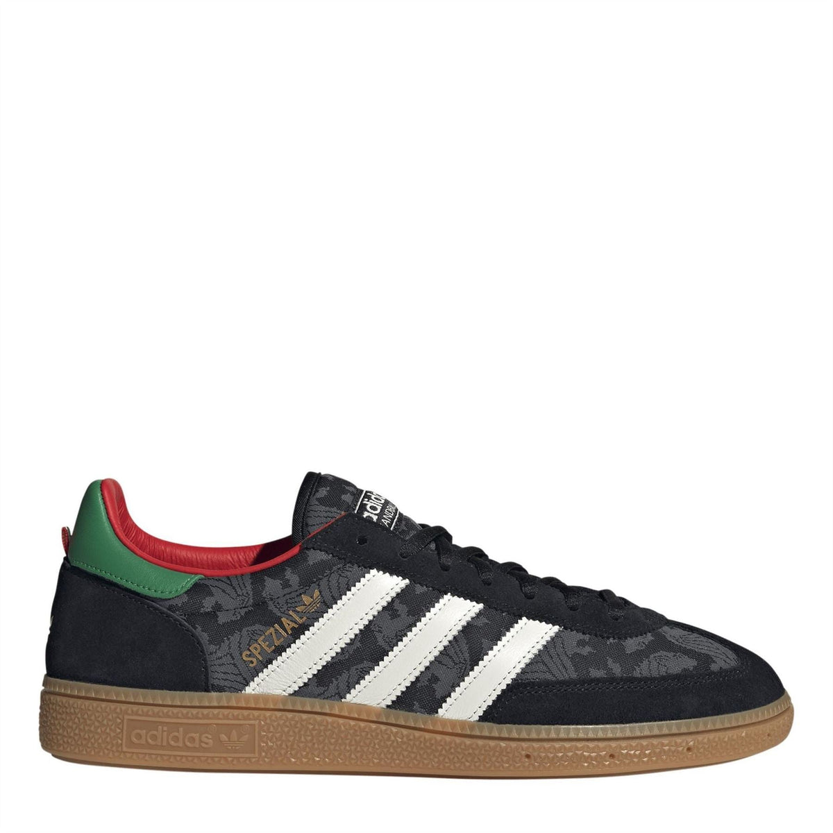 Black low-top trainers with white three stripes, camo upper, green/red heel accents