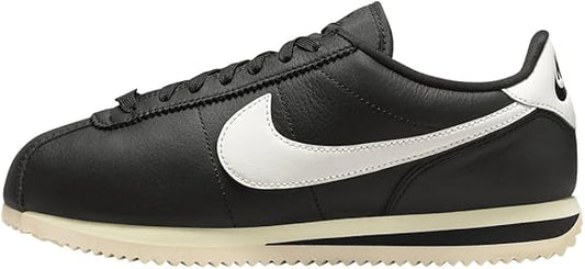 Women's Nike Cortez black leather sneakers with white swoosh and sail midsole