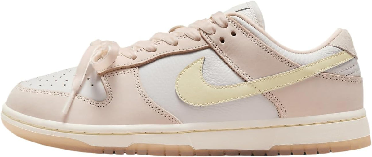 Women's Nike Dunk Low PRM sneakers in light pink with white leather and pale yellow swoosh