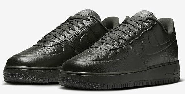 Pair of men's low-top sneakers, dark leather uppers with lace-up and Nike Swoosh