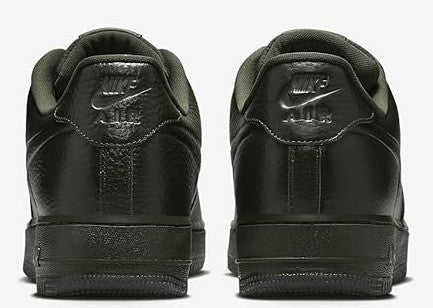 Men's low-top sneakers rear view, dark leather with padded heel and Nike branding