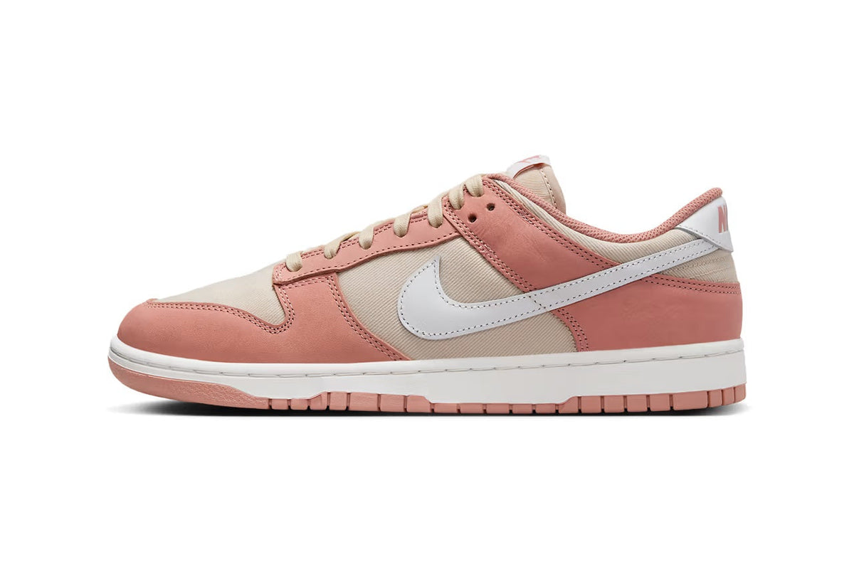 Pink and cream Nike Dunk Low sneakers with white swoosh and lace-up front