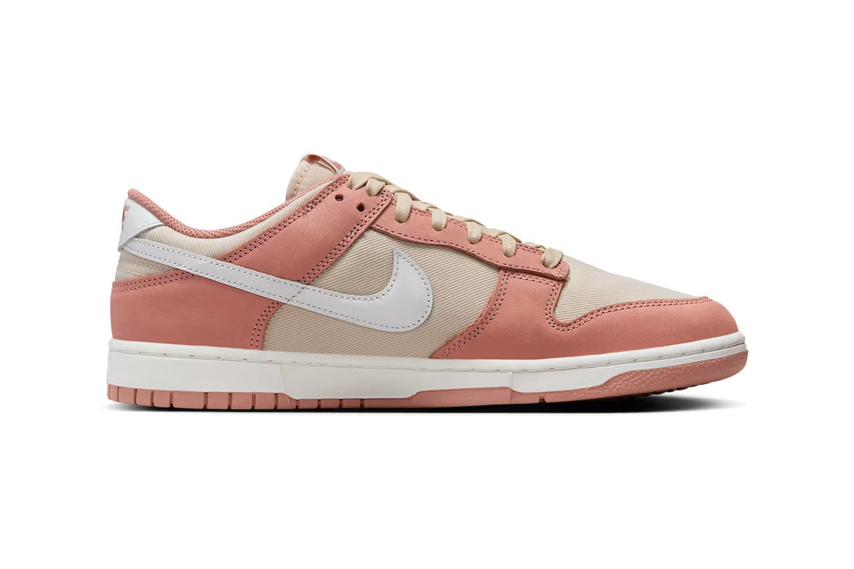Nike Dunk Low low-top sneakers, side view, pink suede with cream panels and white swoosh