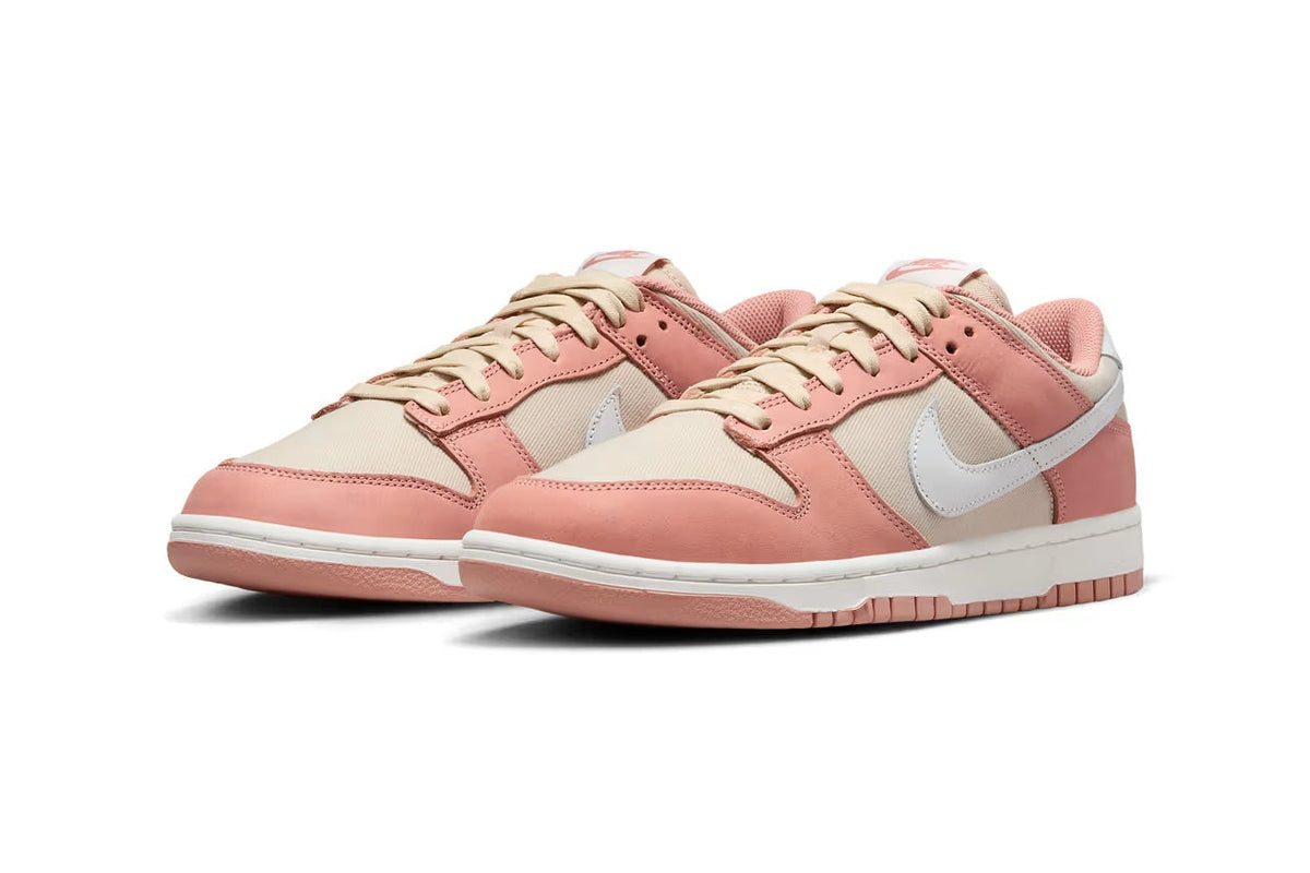 Nike Dunk Low sneakers in pink and cream with white swoosh and lace-up front