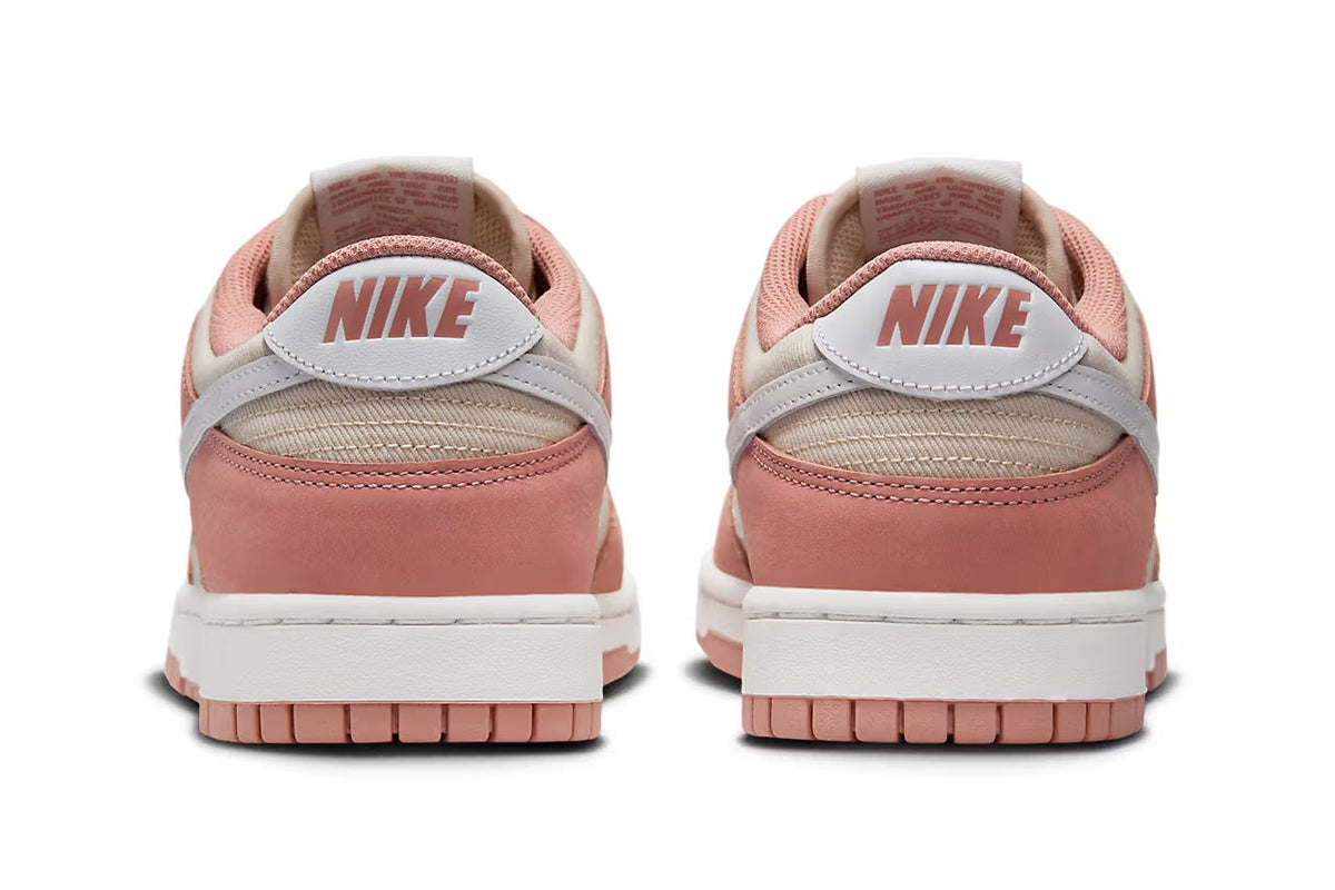 Nike Dunk Low sneakers, heel view, pink suede with NIKE logo on the back