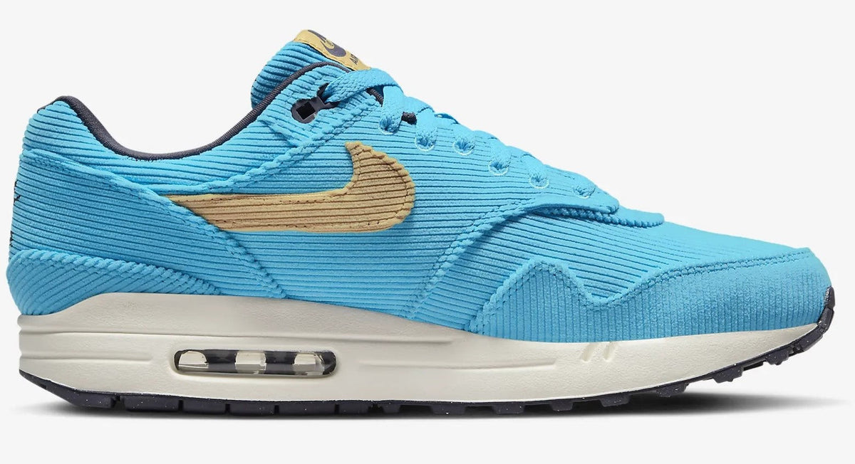 Men's Nike Air Max 1 PRM sneakers, side view, bright blue with tan swoosh and Air unit