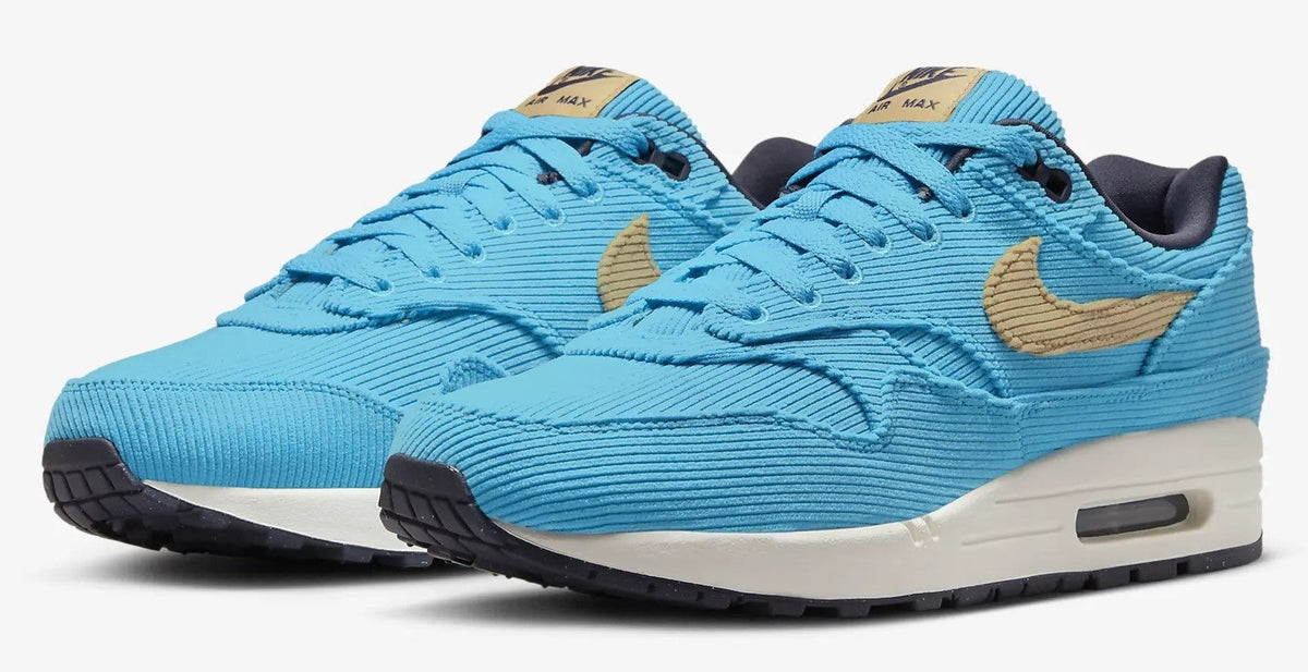 Men's Nike Air Max 1 PRM sneakers, two-quarter angle, bright blue with tan swoosh detailing