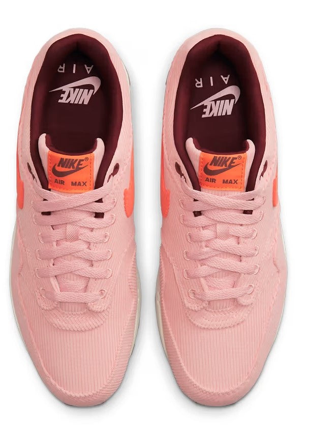Pair of Nike Air Max 1 PRM coral-pink lace-up sneakers, back view with logo branding
