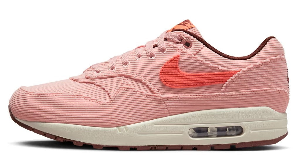Nike Air Max 1 PRM coral-pink lace-up sneakers with orange Swoosh and Air window midsole