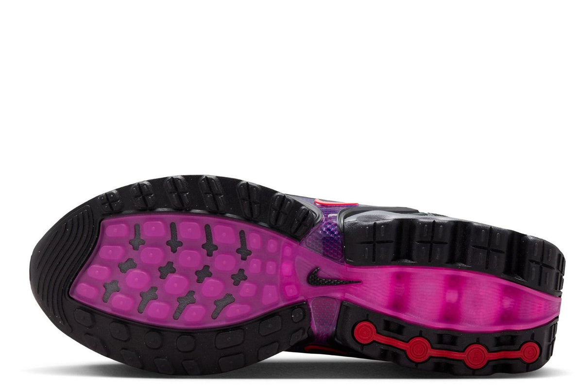 Kids' Nike Air Max DN outsole view with black tread and bright magenta traction