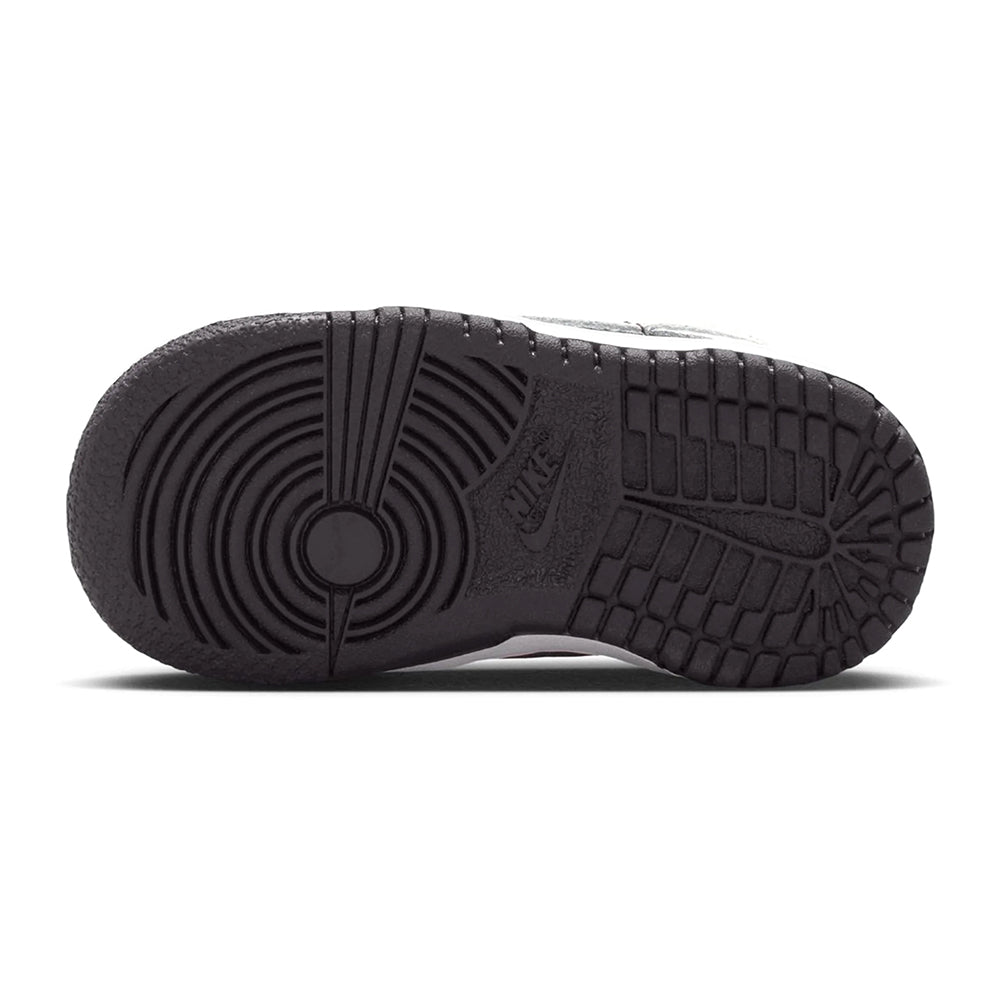 Toddler Nike Dunk Low outsole, dark rubber tread with ridges and circular pivot detail