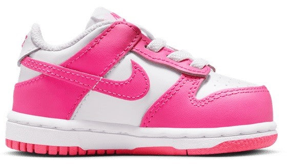 Toddler Nike Dunk Low sneaker side view in white with pink swoosh and lace strap