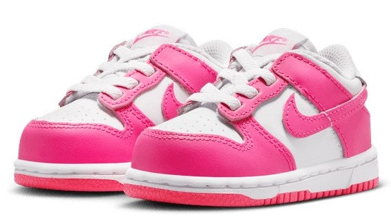 Toddler Nike Dunk Low pair showing white uppers with pink swooshes and velcro straps